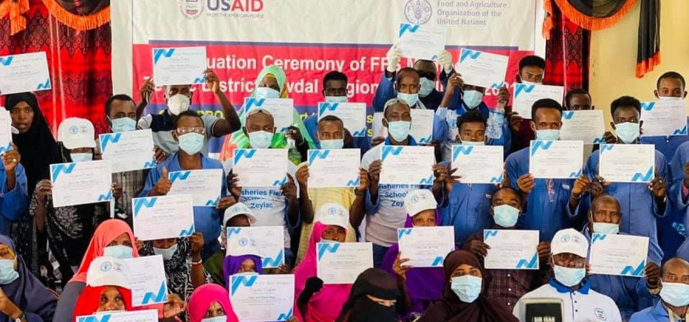 Graduates of the Fisher Field School in Zeila, Somaliland display their new diplomas. Graduates of the Fisher Field School in Zeila, Somaliland display their new diplomas. FAO. USAID. Fishing. Training. Livelihood support.