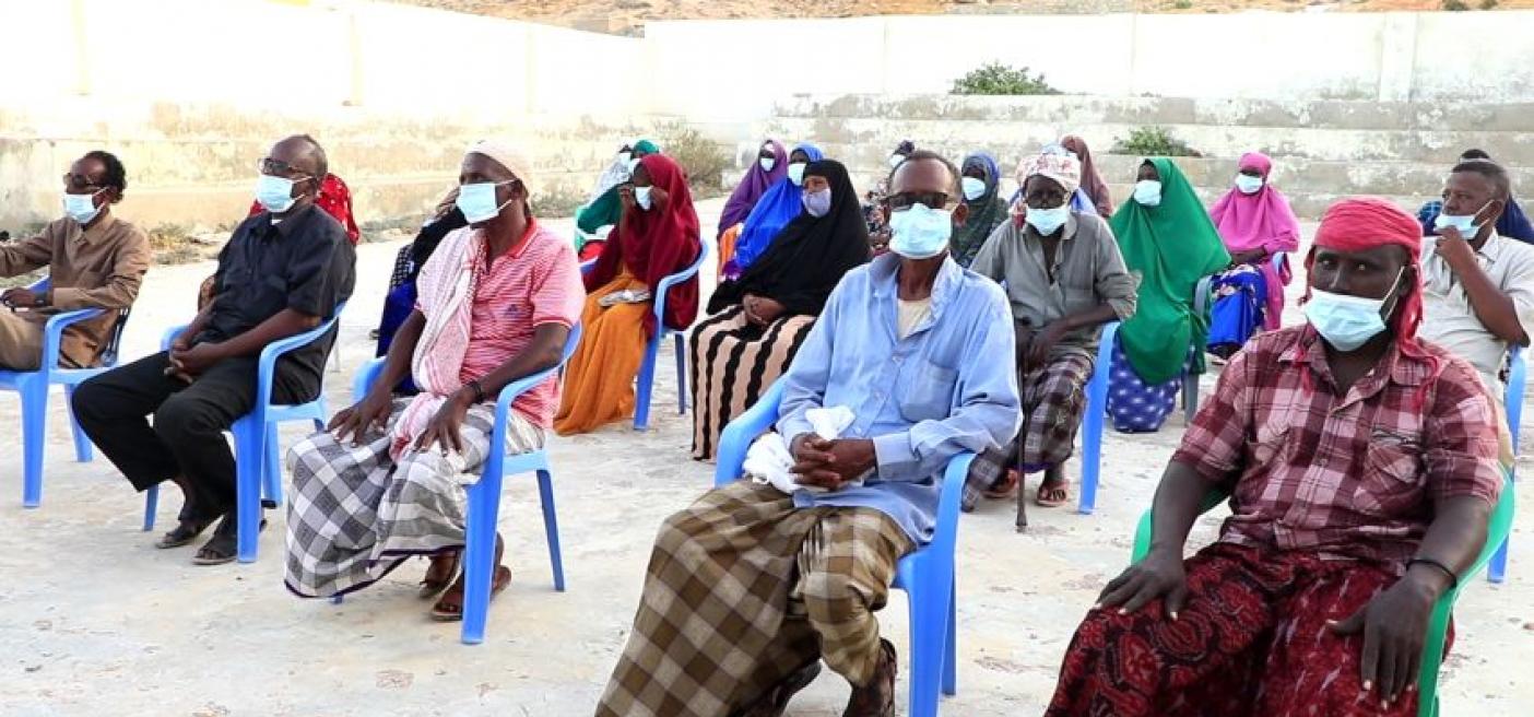 A fisheries co-management meeting with COVID-19 precautions Community members participating in fisheries co-management have an outdoor, socially distanced meeting.